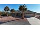 Charming single-story home with desert landscaping and mature palm trees, offering curb appeal and a welcoming atmosphere at 5841 Doubletree Rd, Pahrump, NV 89061