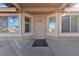 Inviting front porch features security door and neutral tones, with windows, creating a welcoming entrance to the home at 5841 Doubletree Rd, Pahrump, NV 89061
