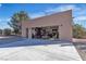 View of an open detached garage with shelves and a table visible inside at 5841 Doubletree Rd, Pahrump, NV 89061