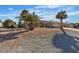 Single story home with desert landscaping, a large front yard, and a long driveway to the garage at 5841 Doubletree Rd, Pahrump, NV 89061