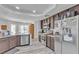 Modern kitchen featuring stainless steel appliances, sleek countertops, and wood-look flooring for a stylish cooking space at 5841 Doubletree Rd, Pahrump, NV 89061