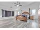 Serene main bedroom with a tray ceiling, ample natural light, and wood-look flooring, creating a peaceful retreat at 5841 Doubletree Rd, Pahrump, NV 89061