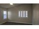 A bedroom featuring carpeted floors and plantation shutters at 6028 Turtle River Ave, Las Vegas, NV 89156