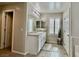 A bathroom featuring granite counters, white cabinets, and plantation shutters at 6145 Scarlet Leaf St, Las Vegas, NV 89148
