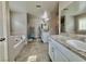 Bathroom with dual granite sink, soaking tub, and walk-in shower at 6145 Scarlet Leaf St, Las Vegas, NV 89148