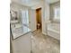 Primary bathroom featuring a soaking tub and granite countertops at 6145 Scarlet Leaf St, Las Vegas, NV 89148