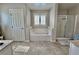 Bright bathroom with a garden tub, tiled surround, and a glass shower at 6145 Scarlet Leaf St, Las Vegas, NV 89148
