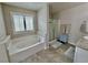 Bathroom featuring soaking tub, walk-in shower and plantation shutters at 6145 Scarlet Leaf St, Las Vegas, NV 89148