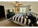 Bright bedroom featuring a ceiling fan and shuttered windows at 6145 Scarlet Leaf St, Las Vegas, NV 89148
