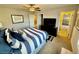 Bright bedroom with a ceiling fan and striped bedding at 6145 Scarlet Leaf St, Las Vegas, NV 89148