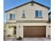 Two-story home with a neutral color palette, a two-car garage, and a well-maintained front yard at 6145 Scarlet Leaf St, Las Vegas, NV 89148