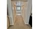 Hallway leading to the primary bathroom with tile floors and neutral tones at 6145 Scarlet Leaf St, Las Vegas, NV 89148