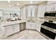 Well-lit kitchen featuring white cabinets, granite countertops, and stainless steel appliances at 6145 Scarlet Leaf St, Las Vegas, NV 89148