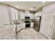 Stylish kitchen with white cabinets, granite countertops, and modern stainless steel appliances at 6145 Scarlet Leaf St, Las Vegas, NV 89148