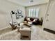 Comfortable living room featuring stylish decor, tiled floors, and bright light from window at 6145 Scarlet Leaf St, Las Vegas, NV 89148
