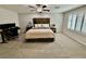 Large main bedroom featuring a ceiling fan, an adjacent desk, and plantation shutters at 6145 Scarlet Leaf St, Las Vegas, NV 89148