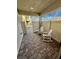 Cozy patio featuring stone pavers and two white rocking chairs provides a charming outdoor seating area at 6145 Scarlet Leaf St, Las Vegas, NV 89148