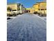 View of the neighborhood street highlighting the paved road and multiple townhomes at 6145 Scarlet Leaf St, Las Vegas, NV 89148