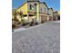 A row of townhomes featuring well-manicured landscaping and a paved driveway at 6145 Scarlet Leaf St, Las Vegas, NV 89148