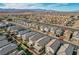 Attractive aerial of a suburban neighborhood showcasing modern homes with landscaped yards and well-maintained streets at 6221 Desert Orchid Way, Las Vegas, NV 89141