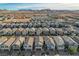 Expansive aerial view of a well-planned community with modern homes set against a backdrop of rolling hills at 6221 Desert Orchid Way, Las Vegas, NV 89141