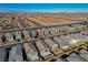 Overhead view of homes in a tidy neighborhood featuring cozy homes and landscaped yards under a bright blue sky at 6221 Desert Orchid Way, Las Vegas, NV 89141