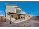 The backyard of this home featuring a covered patio, rockscape, and brick pavers at 6221 Desert Orchid Way, Las Vegas, NV 89141