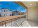 Relax on this private balcony with views of neighboring homes and blue skies at 6221 Desert Orchid Way, Las Vegas, NV 89141
