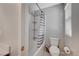 Bright bathroom with a shower-tub combo and a gray and white striped shower curtain at 6221 Desert Orchid Way, Las Vegas, NV 89141