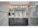 Elegant bathroom featuring double sinks, modern lighting, and a spacious glass-enclosed shower at 6221 Desert Orchid Way, Las Vegas, NV 89141