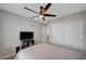 Bedroom with gray carpet, white walls, ceiling fan, and a large closet with sliding doors at 6221 Desert Orchid Way, Las Vegas, NV 89141