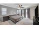 Cozy bedroom includes large windows for natural light and a modern ceiling fan at 6221 Desert Orchid Way, Las Vegas, NV 89141