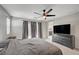 Stylish bedroom features soft carpet, gray curtains, and modern fixtures for comfort at 6221 Desert Orchid Way, Las Vegas, NV 89141