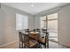 Cozy dining area next to the kitchen with a wood table, six chairs, and a sliding door to the outdoor patio at 6221 Desert Orchid Way, Las Vegas, NV 89141