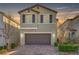 Charming two-story home with a brick driveway and attached two-car garage and manicured landscaping at 6221 Desert Orchid Way, Las Vegas, NV 89141