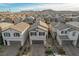 Charming two-story home featuring a neutral color palette, a two-car garage, and a well-maintained front yard at 6221 Desert Orchid Way, Las Vegas, NV 89141