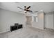 Bright loft boasts plush carpeting, contemporary ceiling fan, and neutral tones, offering versatility at 6221 Desert Orchid Way, Las Vegas, NV 89141