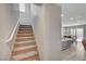 Carpeted staircase leading to the upper level, conveniently located near the kitchen and dining area at 6221 Desert Orchid Way, Las Vegas, NV 89141