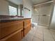 Bathroom featuring a vanity with a dark countertop, tiled floors, and enclosed shower at 6879 Tamarus St # 101, Las Vegas, NV 89119