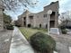 Exterior view of a well-maintained building surrounded by lush landscaping and mature trees at 6879 Tamarus St # 101, Las Vegas, NV 89119