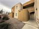 Stucco exterior and desert landscaping create a contemporary look at 6879 Tamarus St # 101, Las Vegas, NV 89119