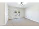 Bright bedroom featuring neutral carpet, white walls, ceiling light and French doors leading to the balcony at 7086 Burcot Ave # A1, Las Vegas, NV 89156