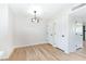 Open dining area showcasing a modern light fixture and a convenient entryway door at 7086 Burcot Ave # A1, Las Vegas, NV 89156