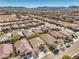 Neighborhood aerial view exhibiting rows of houses, street layout, complemented by mountainous horizon at 7315 Summer Air Ave, Las Vegas, NV 89179