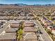 A scenic aerial perspective of a community with neat streets, houses, and a backdrop of majestic mountains at 7315 Summer Air Ave, Las Vegas, NV 89179