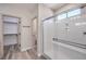 Modern bathroom featuring a glass-enclosed shower with a sleek design and a spacious walk-in closet with built-in shelving at 7315 Summer Air Ave, Las Vegas, NV 89179