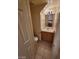 Cozy half bathroom featuring neutral tones, tiled floors, and wood vanity with sink at 7963 Laurena Ave, Las Vegas, NV 89147