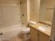 Bathroom featuring a granite countertop vanity, toilet, and a tub-shower combo with tile surround at 7963 Laurena Ave, Las Vegas, NV 89147