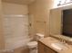 Full bathroom featuring granite countertop vanity, toilet, and shower-tub combo with tile surround at 7963 Laurena Ave, Las Vegas, NV 89147