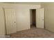 Spacious bedroom featuring neutral walls, carpet, and a door leading to a walk in closet at 7963 Laurena Ave, Las Vegas, NV 89147